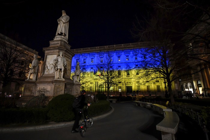 The Palazzo Marino in Milan, Italy, is lit up in the colors of the flag of Ukraine following the Russian attack of Ukraine. Russia is pressing its invasion of Ukraine to the outskirts of the capital after unleashing airstrikes on cities and military bases and sending in troops and tanks from three sides. (Claudio Furlan/LaPresse via AP)