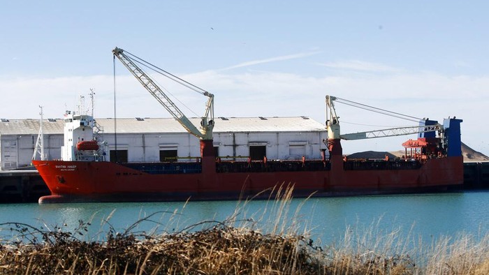 A Russian flag cargo ship docks in the port of Boulogne-sur-Mer, northern France, Saturday, Feb. 26, 2022 . French officials say marines patrolling the English Channel area have intercepted a cargo ship sailing under the Russian flag and escorted it to the port of Boulogne-Sur-Mer for an investigation. The interception of the ship, carrying cars, early Saturday was triggered by financial sanctions levied days ago against Russia for its invasion of the Ukraine. (AP Photo/Michel Spingler)