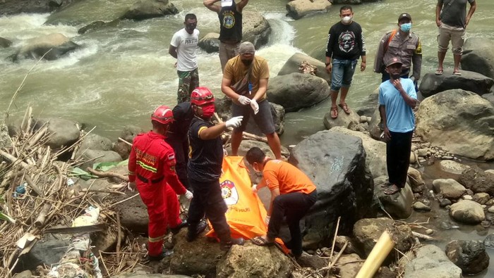Petugas mengevakuasi mayat wanita tanoa identitas di Kali Bolong, Magelang, Minggu (27/2/2022).
