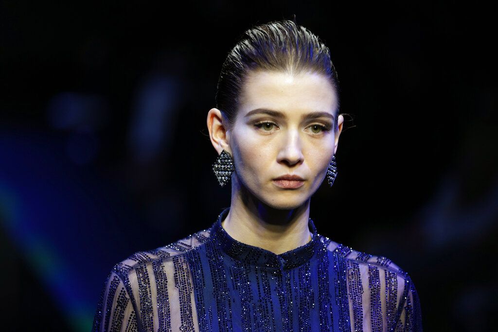 Italian designer Giorgio Armani accepts applause after presentation of his Fall/Winter 2022-2023 fashion collection, unveiled during the Fashion Week in Milan, Italy, Sunday, Feb. 27, 2022. (AP Photo/Luca Bruno)