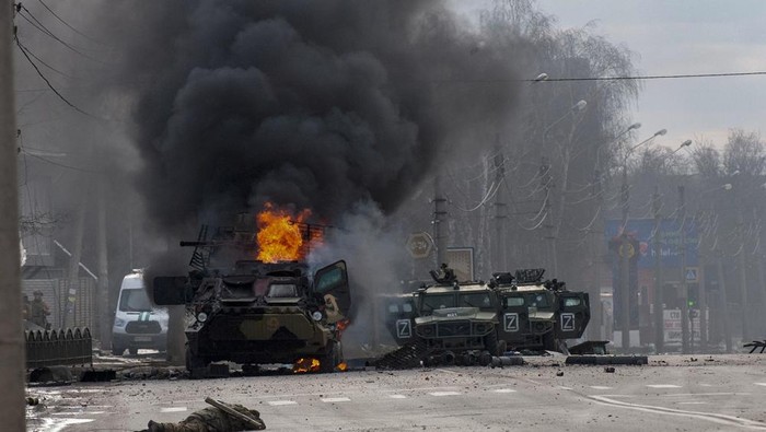 An armored personnel carrier burns and damaged light utility vehicles stand abandoned after fighting in Kharkiv, Ukraine, Sunday, Feb. 27, 2022. The city authorities said that Ukrainian forces engaged in fighting with Russian troops that entered the countrys second-largest city on Sunday. (AP Photo/Marienko Andrew)