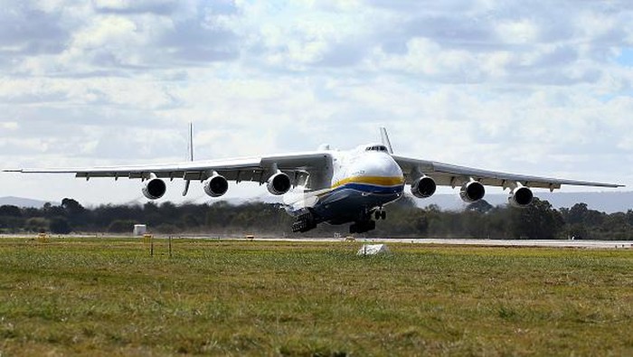 PERTH, AUSTRALIA - MAY 15:  A ground staff member signals to pilots after the arrival of the Antonov AN-225 Mriya at Perth International airport on May 15, 2016 in Perth, Australia. The Ukrainian cargo plane is 84 metres long and has a wingspan of 88.4 metres and is in Perth to  (Photo by Paul Kane/Getty Images)