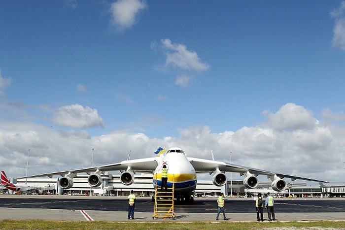 PERTH, AUSTRALIA - MAY 15: A ground staff member signals to pilots after the arrival of the Antonov AN-225 Mriya at Perth International airport on May 15, 2016 in Perth, Australia. The Ukrainian cargo plane is 84 metres long and has a wingspan of 88.4 metres and is in Perth to (Photo by Paul Kane/Getty Images)