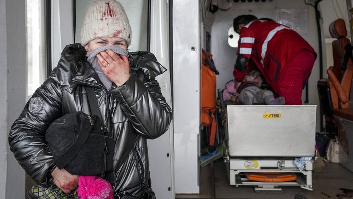 The lifeless body of a girl killed during the shelling of a residential area lies on a medical cart at the city hospital of Mariupol, eastern Ukraine, Sunday, Feb. 27, 2022. (AP Photo/Evgeniy Maloletka)