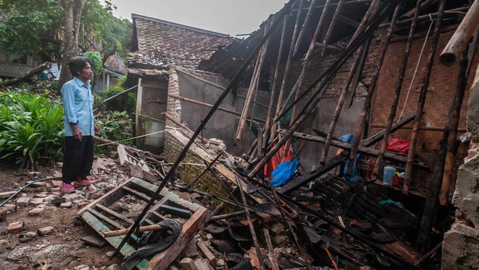 Seorang warga melihat kondisi bagian rumah yang roboh akibat pergerakan tanah di Desa Curug Panjang, Lebak, Banten, Senin (28/2/2022). Rumah rusak akibat pergerekan tanah yang terjadi daerah itu bertambah menjadi 50 rumah seiring dengan seringnya hujan deras mengguyur kawasan tersebut. ANTARA FOTO/Muhammad Bagus Khoirunas/tom.