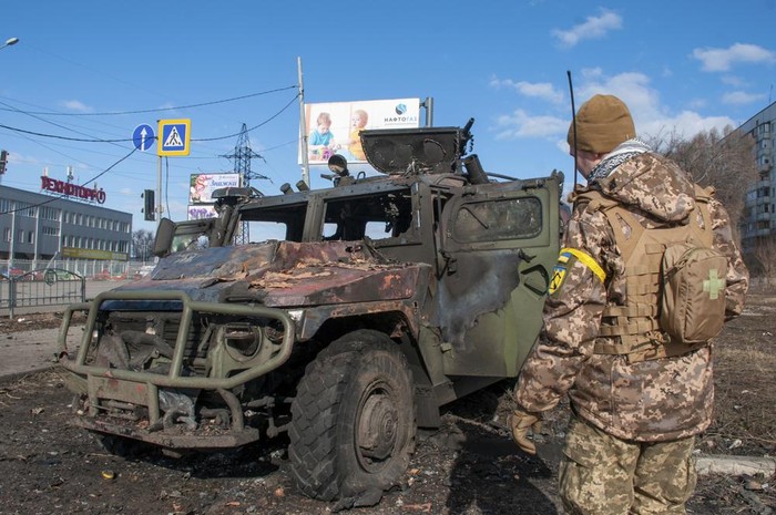 A Ukrainian soldier inspects a damaged military vehicle after fighting in Kharkiv, Ukraine, Sunday, Feb. 27, 2022. The city authorities said that Ukrainian forces engaged in fighting with Russian troops that entered the countrys second-largest city on Sunday. (AP Photo/Marienko Andrew)