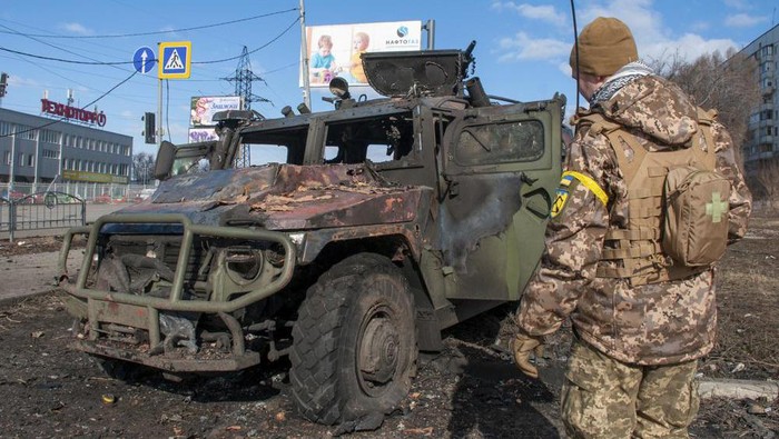 A Ukrainian soldier inspects a damaged military vehicle after fighting in Kharkiv, Ukraine, Sunday, Feb. 27, 2022. The city authorities said that Ukrainian forces engaged in fighting with Russian troops that entered the countrys second-largest city on Sunday. (AP Photo/Marienko Andrew)