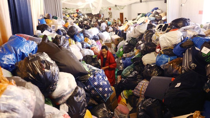 Volunteers sort through donations at the White Eagle Club, ahead of their convoy leaving to deliver aid to those fleeing the Russian invasion in Ukraine, in south London, Britain, February 28, 2022. REUTERS/Henry Nicholls