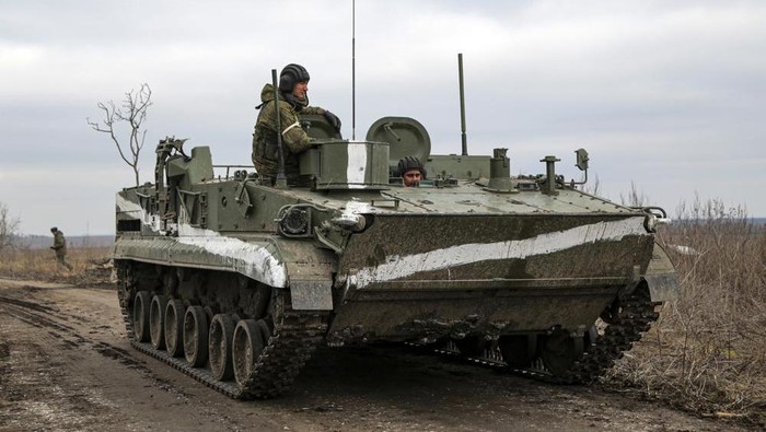 An armored vehicle rolls outside Mykolaivka, Donetsk region, the territory controlled by pro-Russian militants, in eastern Ukraine, Sunday, Feb. 27, 2022. Fighting also raged in two eastern territories controlled by pro-Russia separatists. (AP Photo)