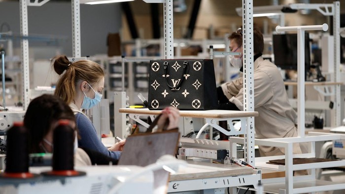 An employee works in a workshop at the Atelier Louis Vuitton in Vendome, France, February 22, 2022. REUTERS/Benoit Tessier