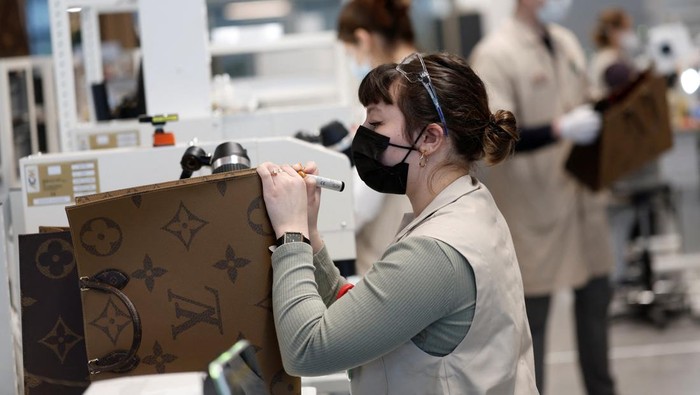 An employee works in a workshop at the Atelier Louis Vuitton in Vendome, France, February 22, 2022. REUTERS/Benoit Tessier