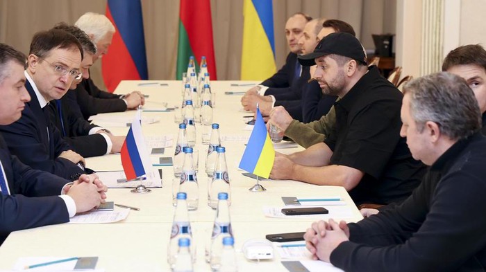 Vladimir Medinsky, the head of the Russian delegation, second left, and Davyd Arakhamia, faction leader of the Servant of the People party in the Ukrainian Parliament, third right, attend the peace talks in Gomel region, Belarus, Monday, Feb. 28, 2022. The Russian and Ukrainian delegations have met for their preliminary talks Monday. The meeting is taking place in Gomel region on the banks of the Pripyat River. (Sergei Kholodilin/BelTA Pool Photo via AP)