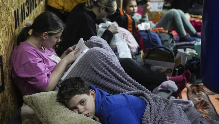 People lie on the floor in the improvised bomb shelter in a sports center, which can accommodate up to 2000 people, in Mariupol, Ukraine, late Sunday, Feb. 27, 2022. Explosions and gunfire that have disrupted life since the invasion began last week appeared to subside around Kyiv overnight, as Ukrainian and Russian delegations prepared to meet Monday, Feb. 28, 2022 on Ukraines border with Belarus. Its unclear what, if anything, those talks would yield. Terrified Ukrainian families huddled in shelters, basements or corridors, waiting to find out. (AP Photo/Evgeniy Maloletka)