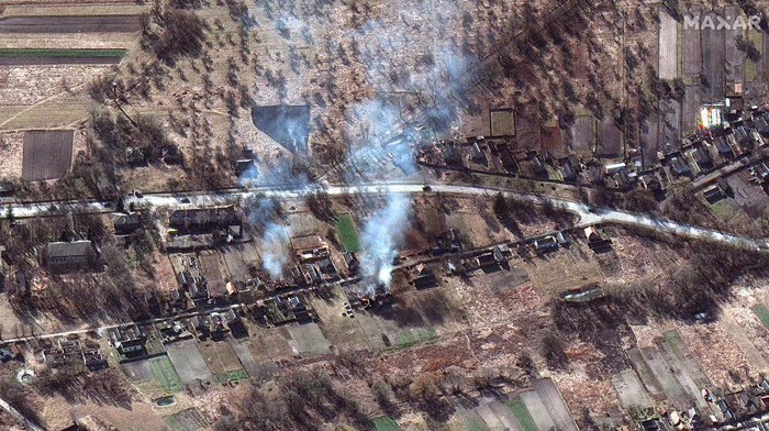 This satellite image provided by Maxar Technologies shows part of military convoy and burning homes northwest of Invankiv, Ukraine Monday, Feb. 28, 2022. (Satellite image ©2022 Maxar Technologies via AP)