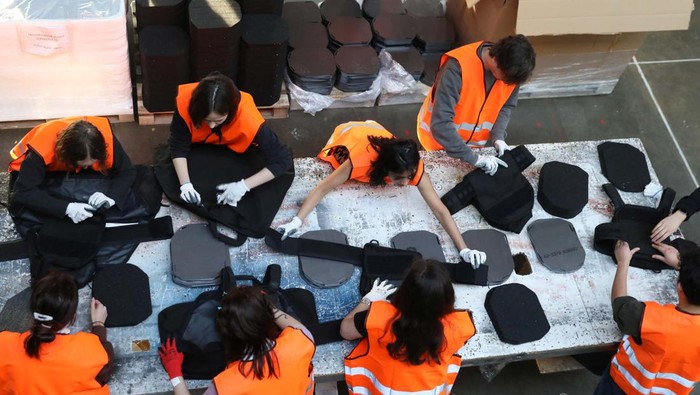 Volunteers assemble flak jackets in a warehouse as a part of a shipment to Ukraine, following Russia's invasion of Ukraine, in Prague, Czech Republic, March 2, 2022. Picture taken March 2, 2022. REUTERS/Eva Korinkova