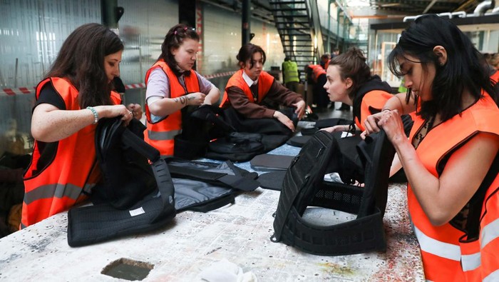 Volunteers assemble flak jackets in a warehouse as a part of a shipment to Ukraine, following Russias invasion of Ukraine, in Prague, Czech Republic, March 2, 2022. Picture taken March 2, 2022.  REUTERS/Eva Korinkova