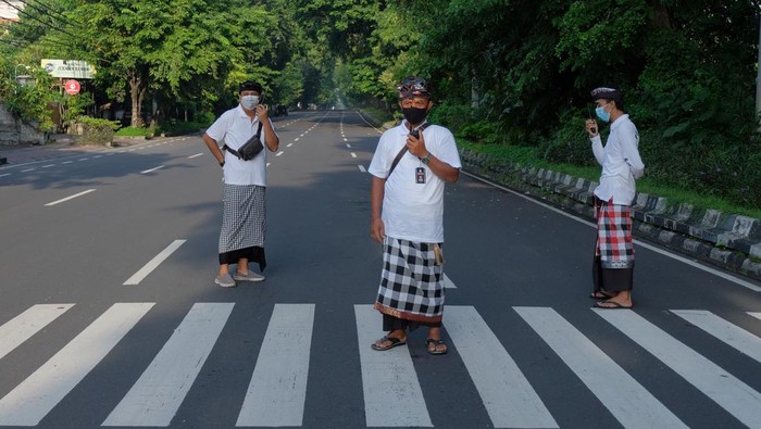 Penampakan Sepinya Bali Saat Nyepi Pecalang atau petugas pengamanan desa adat di Bali memantau situasi jalan raya saat Hari Raya Nyepi Tahun Baru Saka 1944 di wilayah Desa Sumerta Kelod, Denpasar, Bali, Kamis (3/3/2022). Pengamanan Hari Raya Nyepi Tahun Baru Saka 1944 di desa tersebut untuk menjamin keamanan dan kelancaran umat Hindu dalam menjalani