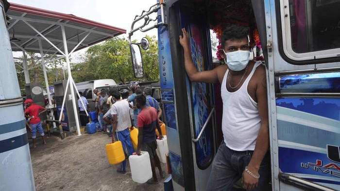 Sri Lankans queue up to buy fuel at a fuel pump in Colombo, Sri Lanka, Thursday, March 3, 2022. Sri Lanka’s already dire economic crisis has deepened as oil prices hover near $110 a barrel. (AP Photo/Eranga Jayawardena)