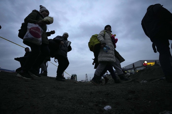 Ukrainian refugees arrive at the border crossing in Medyka, southeastern Poland, Wednesday, March 2, 2022. Seven days into the war, roughly 874,000 people have fled Ukraine and the U.N. refugee agency warned the number could cross the 1 million mark soon. (AP Photo/Markus Schreiber)
