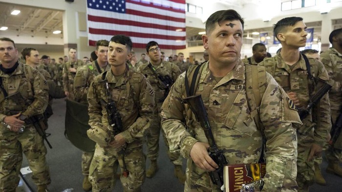 Over 180 soldiers with the U.S. Army 3rd Infantry Division, 1st Armored Brigade Combat Team climb the stairs to a charter airplane at Hunter Army Airfield during their deployment to Germany, Wednesday March 2, 2022 in Savannah, Ga. The division is sending 3,800 troops as reinforcements for various NATO allies in Eastern Europe. (Stephen B. Morton /Atlanta Journal-Constitution via AP)