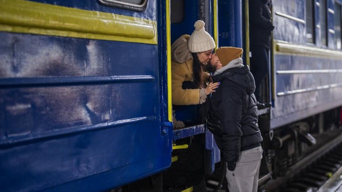 A couple says goodbye before she boards on a train bound for Lviv at the Kyiv station, Ukraine, Thursday, March 3. 2022.