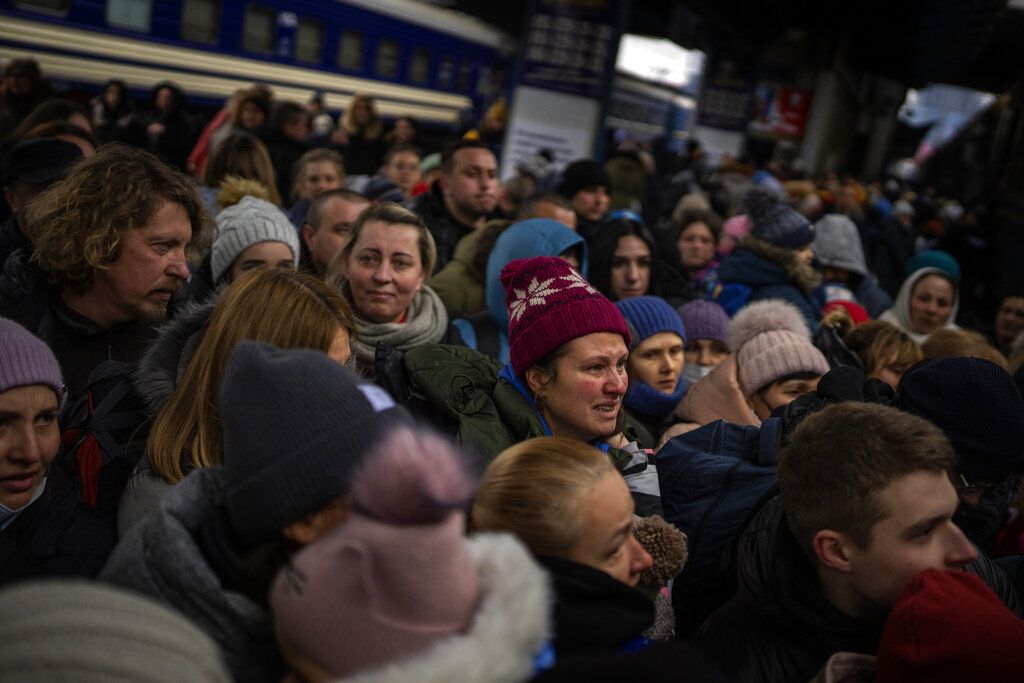 A couple says goodbye before she boards on a train bound for Lviv at the Kyiv station, Ukraine, Thursday, March 3. 2022.