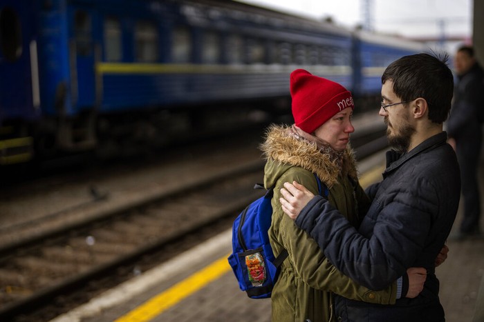 A couple says goodbye before she boards on a train bound for Lviv at the Kyiv station, Ukraine, Thursday, March 3. 2022.