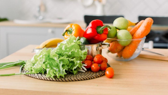 ilustrasi sayuran healthy foods are on the table in home kitchen. Fresh vegetables and utensils for cooking on wooden table. Healthy food, cooking concept sayuran sehat