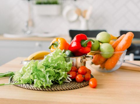 healthy foods are on the table in home kitchen. Fresh vegetables and utensils for cooking on wooden table. Healthy food, cooking concept