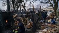 Relawan menyiapkan makanan di tengah hujan rudal Rusia, di luar stasiun Lviv, Ukraina barat, Kamis (3/3/2022). Invasi Rusia menyebabkan jutaan warga kehilangan tempat tinggal hanya dalam satu pekan.