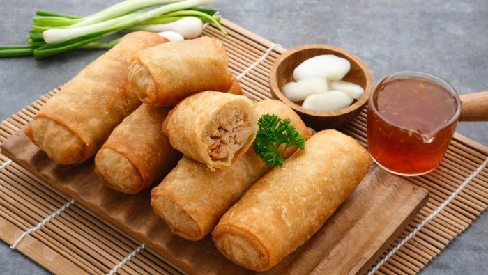 Lumpia or lunpia, a traditional snack from Semarang, Central Java, Indonesia. Traditional Spring rolls food containing sauted bamboo(rebung), eggs, and chicken or shrimp. Selective focus image.