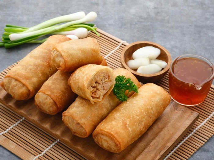 Lumpia or lunpia, a traditional snack from Semarang, Central Java, Indonesia. Traditional Spring rolls food containing sauted bamboo(rebung), eggs, and chicken or shrimp. Selective focus image.