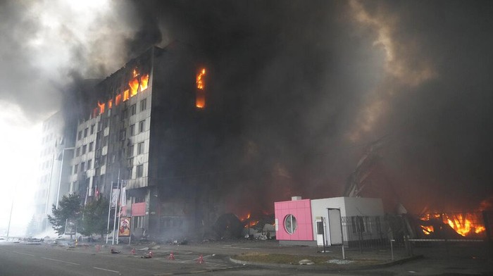 Firefighters hose down a burning building after bombing in Kyiv, Ukraine, Thursday, March 3, 2022. (AP Photo/Efrem Lukatsky)
