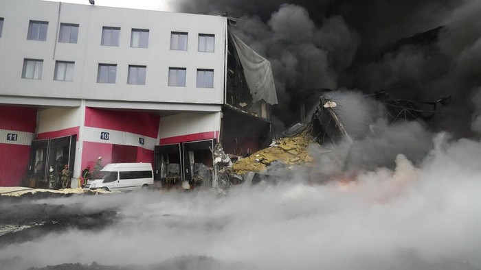 Firefighters hose down a burning building after bombing in Kyiv, Ukraine, Thursday, March 3, 2022. (AP Photo/Efrem Lukatsky)