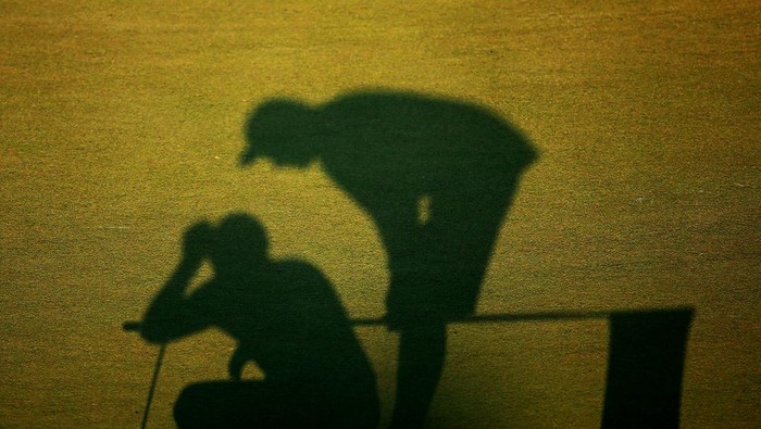 Ilustrasi caddy golf bersama pemain golf usai pertandingan.