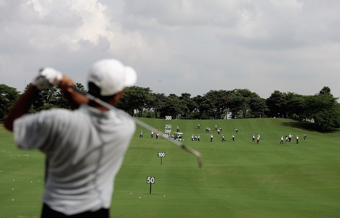 JAKARTA, INDONESIA - MARCH 23:  The local club caddy?s pick up the balls on the driving range during the Pro-Am of the Indonesia Open 2005 at the Cengkareng Golf Club on March 23, 2005 in Jakarta , Indonesia.  (Photo by Ian Walton/Getty Images)