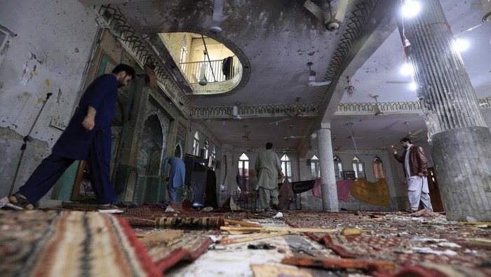 A man walks amid the damages at the prayer hall after a bomb blast inside a mosque during Friday prayers in Peshawar, Pakistan, March 4, 2022. REUTERS/Fayaz Aziz