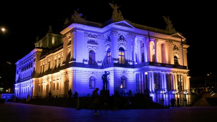 A view shows the facade of the Opernhaus Zurich opera illuminated in the colours of the Ukrainian flag in support of their people, after Russia's invasion of Ukraine, in Zurich, Switzerland March 4, 2022. REUTERS/ArndWiegmann