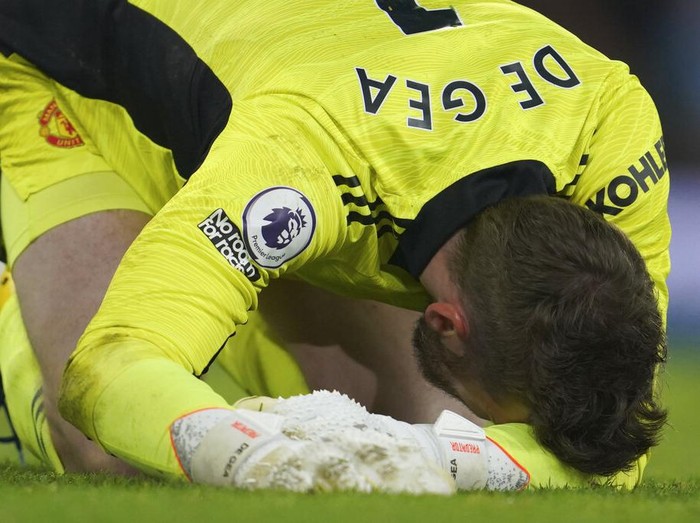 Manchester United's goalkeeper David de Gea, center, fails to save the ball as Manchester City's Riyad Mahrez, left, scores his side's third goal during the English Premier League soccer match between Manchester City and Manchester United, at the Etihad stadium in Manchester, England, Sunday, March 6, 2022. (AP Photo/Jon Super)