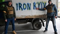 Begini gaya duo Klitschko di medan perang Rusia vs Ukraina. Wladimir dan Vitali berpose di depan spanduk bertulis Iron Kyiv, mirip dengan julukan Vitalis emasa aktif bertinju, yang dijuluki Dr. Ironfist. (Foto: GENYA SAVILOV/AFP)