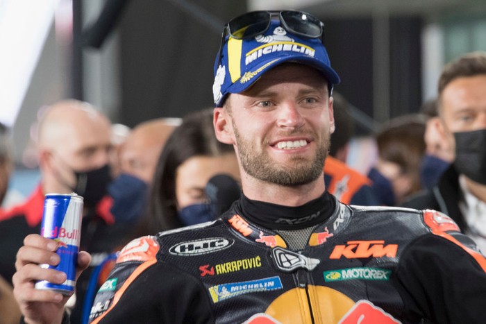 DOHA, QATAR - MARCH 06: Brad Binder of South Africa and Red Bull KTM Factory Racing  celebrates the second place  under the podium during the MotoGP race during the MotoGP of Qatar at Losail Circuit on March 06, 2022 in Doha, Qatar. (Photo by Mirco Lazzari gp/Getty Images,)