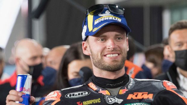 DOHA, QATAR - MARCH 06: Brad Binder of South Africa and Red Bull KTM Factory Racing  celebrates the second place  under the podium during the MotoGP race during the MotoGP of Qatar at Losail Circuit on March 06, 2022 in Doha, Qatar. (Photo by Mirco Lazzari gp/Getty Images,)