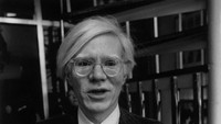 Seniman asal AS, Andy Warhol berdiri di depan restoran Mr Chows di London untuk mengumumkan penerbitan bukunya.  Foto: Getty Images/John Minihan