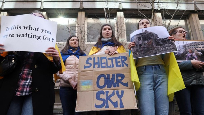 People hold signs during a demonstration in support of Ukraine outside the German Embassy, after Russia's invasion of Ukraine, in Brussels, Belgium, March 11, 2022. REUTERS/Yves Herman