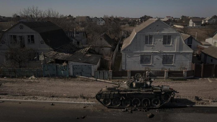 A destroyed tank is seen after battles between Ukrainian and Russian forces on a main road near Brovary, north of Kyiv, Ukraine, Thursday, March 10, 2022. (AP Photo/Felipe Dana)