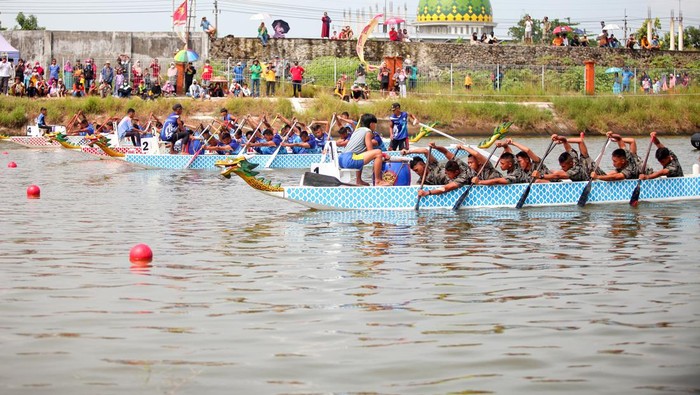 LOMBA DAYUNG PERAHU NAGA Komandan Pasmar 2 Brigjen TNI (Mar) Suherlan menyerahkan piala kepada pemenang lomba dayung perahu naga dalam rangka HUT ke-21 Pasmar 2, di Long Storage Kalimati Desa Kwatu, Mojoanyar, Mojokerto, Jawa Timur, Minggu (13/3/2022). Lomba yang diikuti 58 tim dari empat kategori tersebut bertujuan menjaring atlet muda potensial andalan di ajang nasional maupun internasional. ANTARA FOTO/Umarul Faruq/hp.