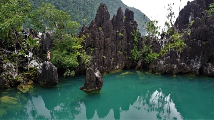 Wisatawan berada diatas batu karst di lokasi Wisata Blue Lagoon Desa Labengki Kecil, Konawe Utara, Sulawesi Tenggara, Minggu (13/3/2022). Wisatawan domestik dan mancanegara banyak mendatangi wisata Blue Lagoon di Labengki meski akses menuju lokasi itu belum memiliki akses jalan yang memadai. ANTARA FOTO/Jojon./foc.