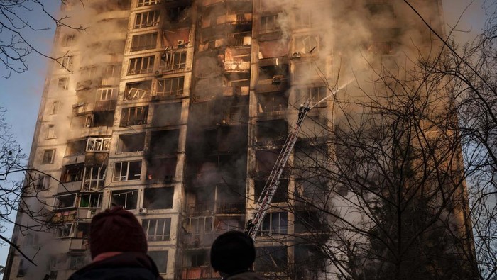 Ukrainian firefighters work in an apartment building after bombing in Kyiv, Ukraine, Tuesday, March 15, 2022. (AP Photo/Felipe Dana)