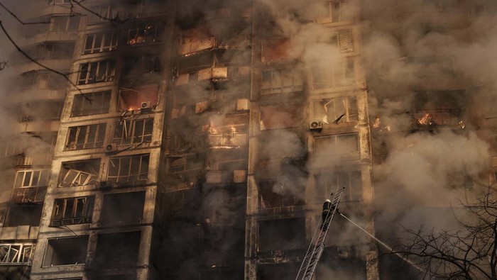 Ukrainian firefighters work in an apartment building after bombing in Kyiv, Ukraine, Tuesday, March 15, 2022. (AP Photo/Felipe Dana)