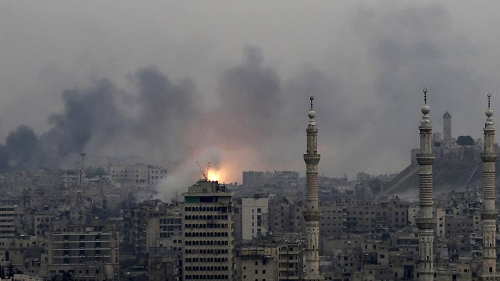 FILE - A ball of fire rises following a Syrian government air strike that hit rebel positions in the eastern neighborhoods of Aleppo, Syria, Monday, Dec. 5, 2016. Tuesday, March 15, 2022 marks the 11th anniversary of Syrias revolution-turned-civil war. This year, many survivors are watching in shock as Ukrainians face the same horrors they did. (AP Photo/Hassan Ammar, File)